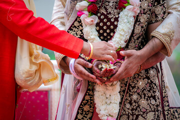 Indian Hindu couple's hands close up, wedding ceremony, religious items and rituals, pooja