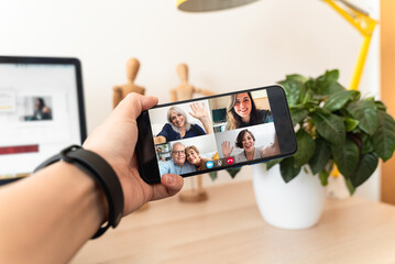Father mother and daughters talking in video conference at home during coronavirus lockdown -...