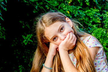 Beautiful teenage girl covered her mouth with her hand