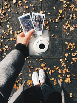 Woman holding polaroids