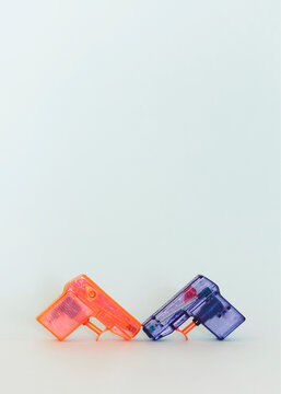 Toy water guns leaning one against the other