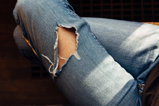 Woman's legs with ripped jeans