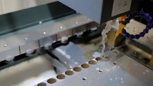 Metalworking, industrial, machining, technology, manufacturing, equipment concept. Automatic electric cnc wire cutting machine working with sheet metal workpiece with sparks at factory: slow motion