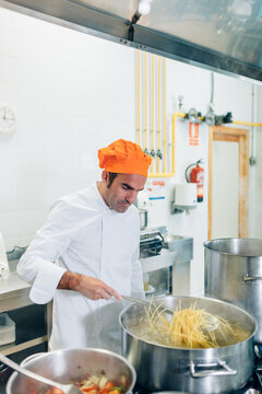 Chef Cooking Pasta in a School Kitchen