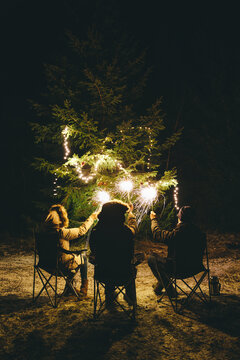 Group sitting with sparklers outside