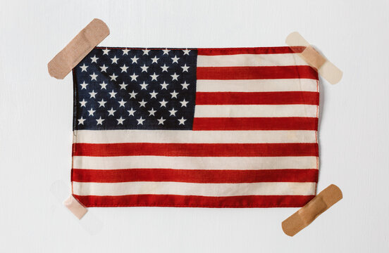 American flag held to wall with band aids
