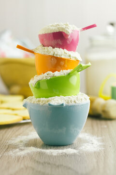Measuring cups overflowing with flour