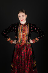 Fototapeta premium Young beautiful slovak woman in traditional dress. Slovak folklore