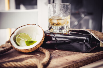 bottle of rum with lime ice and coconut