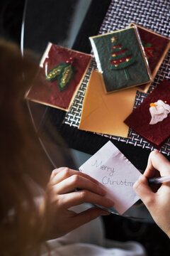 Girl writing on a Christmas card
