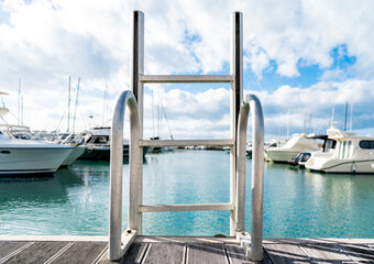 Ladder into the water of the little harbor of the marina of San Vincenzo, province of Livorno,...