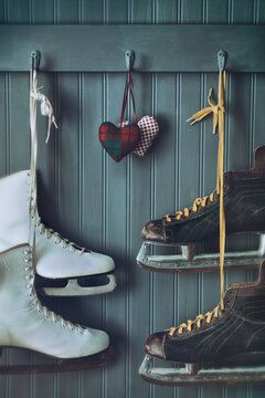 Woman and men skates on coat hooks with hearts