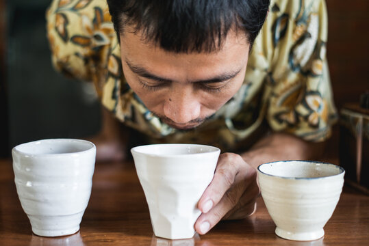 Asian barista making drip coffee