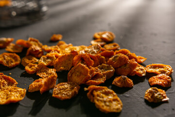 top view of several golden berries on black textured background with a flash on top