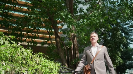 adult senior businessman or CEO manager are walking in the city urban with bicycle, worker eco lifestyle in city park, business life - Powered by Adobe