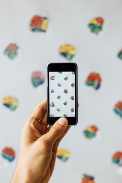Detail of man hand taking picture of pattern wall