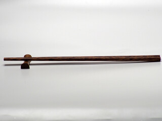Close up shoot of a pair of wooden chopsticks on a white isolated background