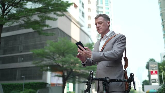 businessman talk by using smart phone to work in business, concept of technology and online social network communication, freelance worker lifestyle with city urban background, slow-motion shot