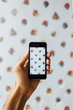 Detail of man hand taking picture of pattern wall