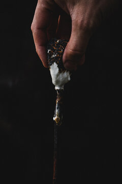 Pulling a sticky marshmallow off a stick