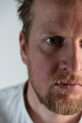 Close up portrait of a man where he is angry looking forward through his forehead and hair is drilled