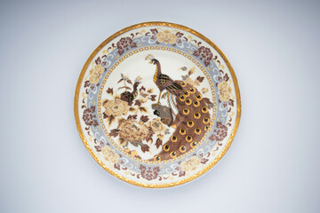 Painted pattern on a plate on a white background