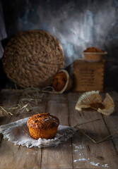 Fresh muffins on a rustic table
