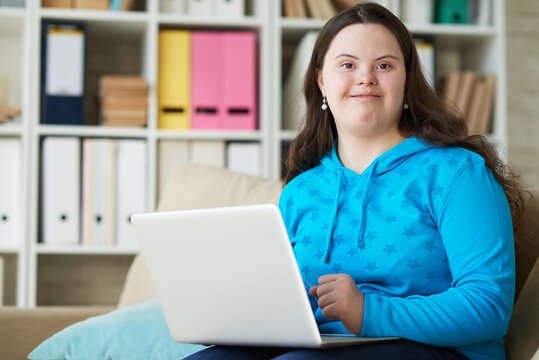 Happy mentally challenged woman with laptop