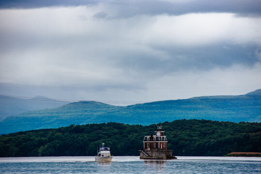 Boat passing a lighthouse on a river