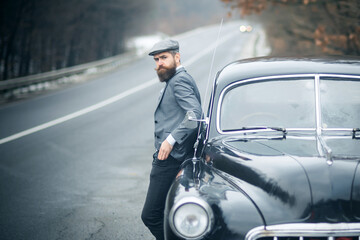 Nostalgia and retro car at bearded man. Vintage guy