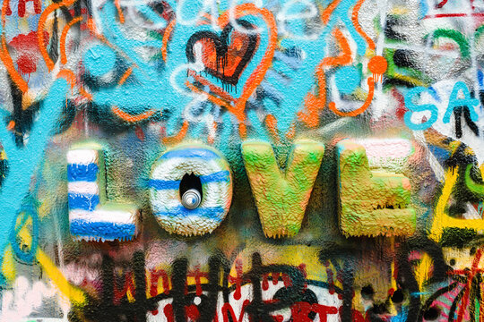 The word ""love"" on a spray painted wall