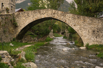 Fototapeta na wymiar Stone bridge in Sallent de Gallego town, located in Hueca, Aragon, Spain.