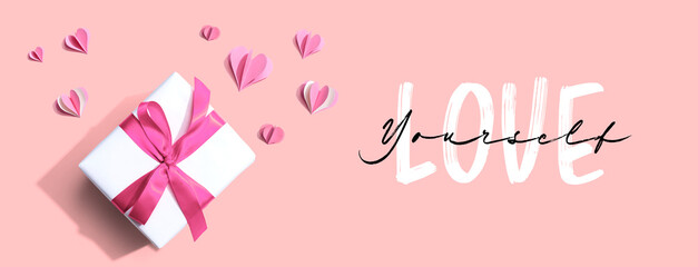 Love Yourself message with a gift box and paper hearts