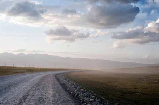 Landscapes with a dirt road to the mountains