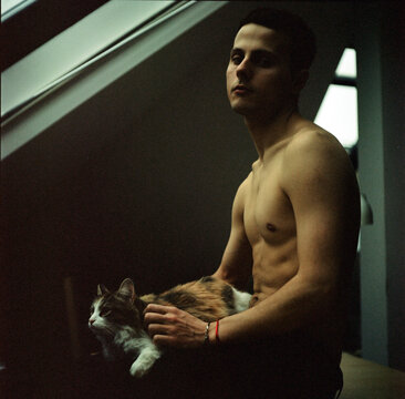 A portrait of a beautiful man with a cat