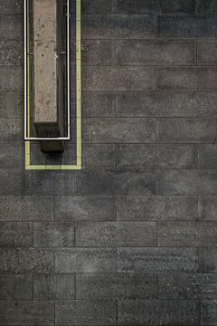 Dark stone floor, railing and yellow line, seen from above