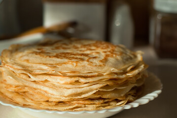 homemade pancakes. in the photo, pancakes cooked at home, illuminated by sunlight in the kitchen, close-up