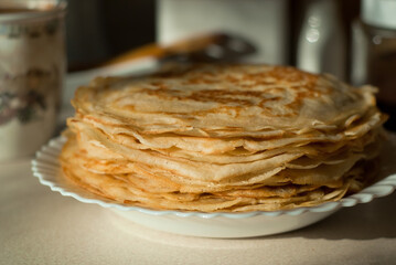 homemade pancakes. in the photo, pancakes cooked at home, illuminated by sunlight in the kitchen, close-up