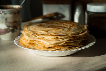 homemade pancakes. in the photo, pancakes cooked at home, illuminated by sunlight in the kitchen, close-up