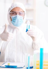 Young chemist student working in lab on chemicals