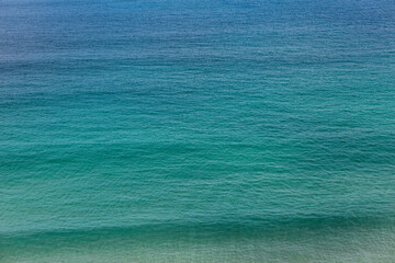 A portrait seascape gradient blending from blue to aqua to sea green