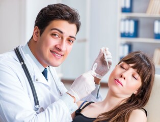 Doctor checking patients ear during medical examination