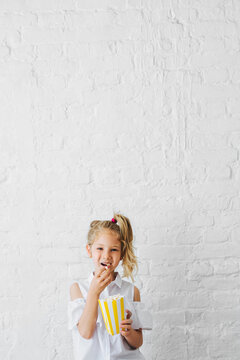 Portrait of Pretty Girl Preschooler Eating Popcorns