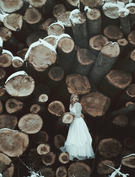 Girl standing on a woodpile