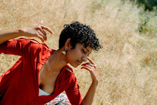Spiritual images of a South Indian woman stretching and dancing in her backyard