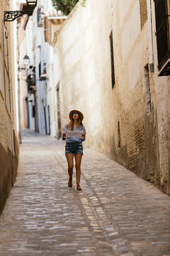 Woman doing tourism with map at Granada, Spain.