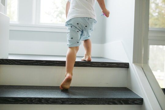 Little boy's feet climbing stairs
