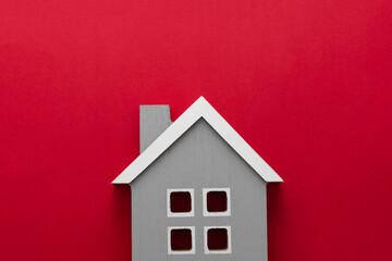 Fototapeta na wymiar House insurance and mortgage, buying or rent concept.Wooden model house over red background, top view with copy space