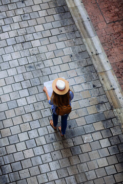Woman doing tourism with map at Granada, Spain.