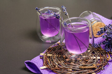 Fresh lavender violet cocktail on black stone concrete background